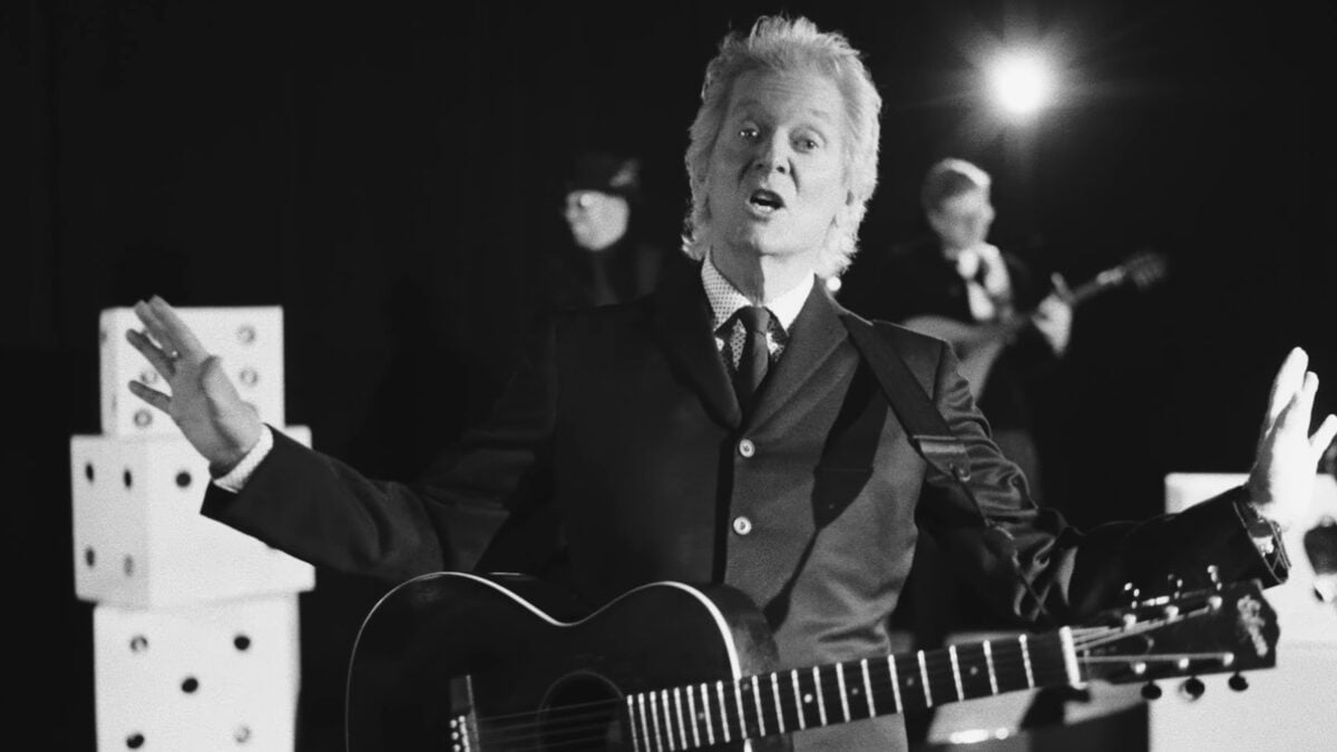 Rodney Crowell Sports John Lennon’s ‘A Hard Day’s Night’ Suit In ‘Lucky’ Video