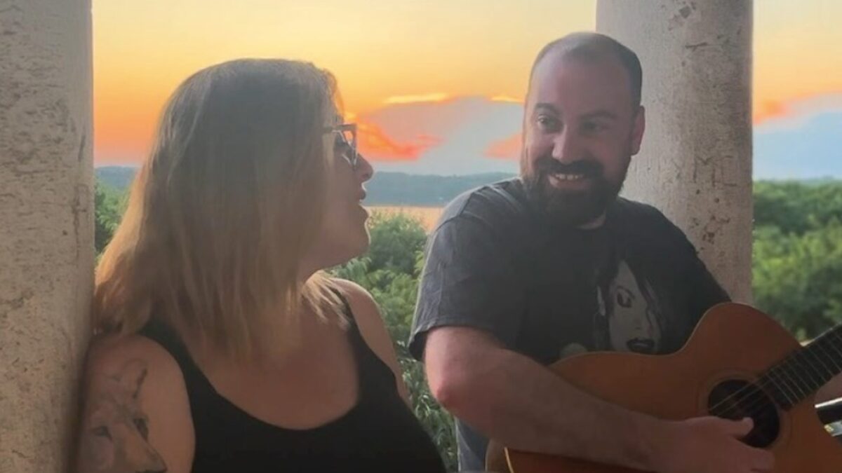 Watch Jennifer Hartswick & Lyle Divinsky Deliver Gorgeous ‘Angel From Montgomery’ Cover As Sun Sets In Croatia